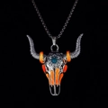 Detailed macro view of vintage bull skull pendant with turquoise stone and orange inlay - Orange Light