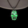 Detailed close-up of punk style skull necklace with glowing green fluorescent effect - Green