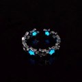 Macro shot of luminous hollow star ring with glowing ice blue light in the darkness - Silver Blue Glow