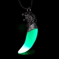 Detailed macro view of the punk style lion head wolf tooth pendant glowing in the dark - Antique Silver Green Glow