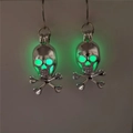 Detailed view of silver skull earrings with green luminous glow in the dark features - Silver Green Glow