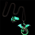 Detailed close-up of luminous dragon jewelry set with glowing green wings in the dark - Green