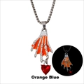 Gothic skeletal hand pendant with red heart zircon and orange glow in the dark effect - Luminous Orange
