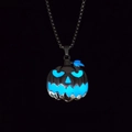 Macro shot of Halloween pumpkin charm glowing with bright blue light in the dark night - Blue