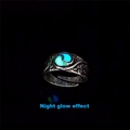 Macro shot of glow-in-the-dark rotating ring featuring embossed Tai Chi patterns on band - Ancient Silver Blue + Green Glow