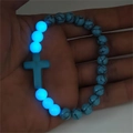 Detailed close-up showing the luminous glow of blue turquoise cross beads in low light - Blue Turquoise Blue Glow