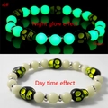 Luminous skull stretch bracelet showing bright green glow effect in dark vs day view - Lemon Yellow Skull Green Glow