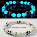 Luminous Halloween skull bead bracelet showing daylight and light blue night glow effect - Black & White Skull Blue-Green Glow