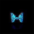 Detailed close-up of luminous butterfly ring with blue glow effect on black background - Blue Glow