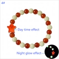 Macro detail of Day of the Dead luminous beads showing daytime and night glow effect - Orange-Red Glow