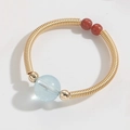 Handmade gold wire ring featuring light blue aquamarine and red agate accent beads - Aquamarine Style