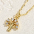 Macro view of 14K gold plated tree of life pendant featuring six sparkling cubic zirconia - Tree of Life / 14K Gold