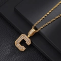 Close-up of golden letter C pendant necklace with sparkling zircons on a black base - Letter C / Rope Chain Necklace / Gold