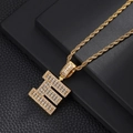 Close-up of golden letter E pendant with baguette cubic zirconia and rope chain - Letter E / Rope Chain Necklace / Gold
