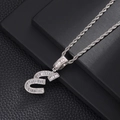 Macro shot of silver letter E pendant with cubic zirconia stones on rope chain - Letter E