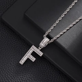 Macro detail of iced-out letter F pendant with zircon stones and silver rope chain - Letter F