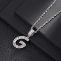 Detail of silver G letter pendant with zircon inlay and twisted rope chain necklace - Letter G
