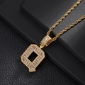 Detailed macro view of the gold-plated letter Q pendant with zircon stones and rope chain - Letter Q / Rope Chain Necklace / Gold
