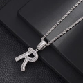 Detailed view of silver R-letter pendant with pave-set zircons on a rope chain - Letter R
