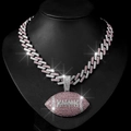 Detailed macro of iced out rugby pendant necklace on black display with sparkling pink crystals - Silver Pink Pendant Necklace