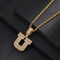 Detailed close-up of a gold rope chain necklace with a zircon-encrusted letter U pendant - Letter U / Rope Chain Necklace / Gold