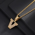 Macro detail of gold plated letter V pendant with micro paved cubic zirconia stones - Letter V / Rope Chain Necklace / Gold