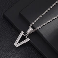 Macro shot of silver hip hop V pendant with iced out cubic zirconia on rope chain - Letter V
