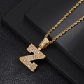 Macro shot of gold hip-hop necklace with letter Z pendant and white cubic zirconia - Letter Z / Rope Chain Necklace / Gold
