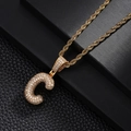Detailed macro view of gold letter C pendant with pavé cubic zirconia on a rope chain - Letter C Style