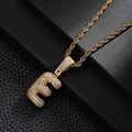 Macro shot of gold letter E pendant with cubic zirconia inlay on rope chain - Letter E Style