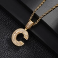 Macro shot of gold-plated letter C pendant with sparkling pavé cubic zirconia on rope chain - Letter C Style