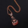 Macro detail of bronze alloy Halloween evil pumpkin pendant with red accents and white rhinestone - Bronze Pendant With Twist Chain