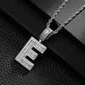 Macro detail of iced-out hip hop letter E pendant with baguette diamonds on rope chain - Letter E