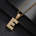 Detailed close-up of a gold-plated letter E pendant with baguette-cut cubic zirconia - Letter E Style