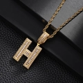 Macro detail of iced out gold plated H letter pendant with sparkling zircon stones - Letter H Style