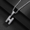Macro detail of silver iced-out letter H hip hop pendant with cubic zirconia stones - Letter H (20inch Silver Rope Chain)
