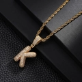 Macro detail of gold twisted rope chain with capital letter K pendant set with zircons - Letter K Style