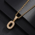 Macro shot of gold-plated letter O pendant with cubic zirconia and twisted rope chain - Letter O Style