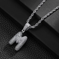 Detailed macro of silver-colored bubble letter M pendant with pave-set cubic zirconia - Letter M (20inch Silver Rope Chain)