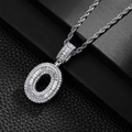 Macro shot of silver-tone letter O pendant with baguette-cut stones and rope chain - Letter O