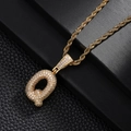 Macro shot of iced out bubble letter Q pendant with gold rope chain and zircon stones - Letter Q Style