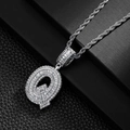 Macro shot of silver hip hop Q letter pendant with micro-pave zircons and rope chain - Letter Q
