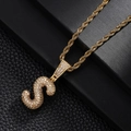 Close-up of golden letter S pendant necklace with shimmering cubic zirconia micro-pave - Letter S Style