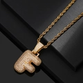 Macro shot of gold-plated letter F pendant with pavé cubic zirconia and rope chain - Letter F / Gold
