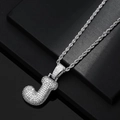 Macro view of iced out letter J pendant with white zircon stones on a silver rope chain - Letter J / Silver