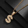 Macro shot of gold letter S pendant with baguette and round cubic zirconia stones - Letter S Style