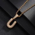 Macro detail of gold U-letter pendant with pavé zircons and elegant rope chain - Letter U Style