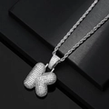 Macro detail of iced-out bubble letter K pendant with sparkling zircon stones on rope chain - Letter K / Silver