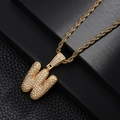 Macro shot of hip-hop style letter W pendant with sparkling zircons and gold rope chain - Letter W Style