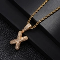 Close-up of golden letter X pendant with paved zircons and a twisted rope chain - Letter X Style